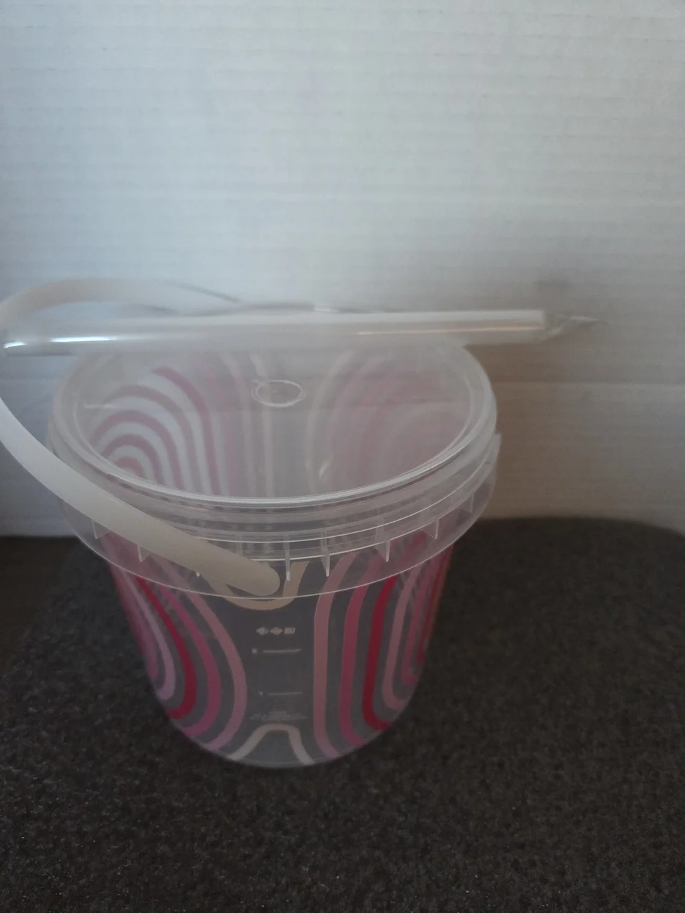 Dunkin' 48 oz. bucket cup with unopened straw.